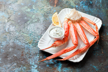 Crab leg with tartar sauce, selective focus
