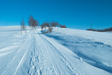 Fototapeta na wymiar winter road with blue sky