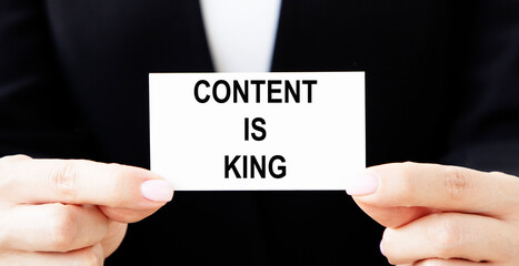 The content is a CONTENT IS KING on a white ring binder Notepad with a hand pencil, a Digital business concept