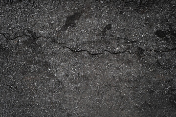 Crack background texture of rough asphalt top view