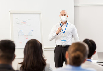 business, education and pandemic concept - businessman in mask for protection from virus disease...