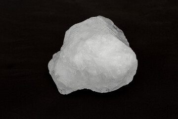 White crystal alum stone isolated on black background.