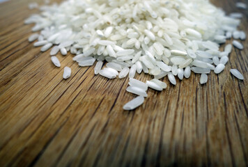 Fototapeta premium White rice on wooden board close-up.