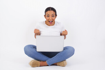 Close up portrait of stylish modern lady with wave hairstyle raising fists up isolated on shine grey background big eyes and wide open mouth.