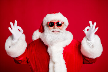 Close-up portrait of his he nice handsome content glad cheerful cheery bearded Santa father showing two double ok-sign cool good isolated over bright vivid shine vibrant red color background