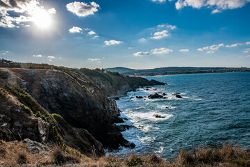 Water next to a mountain in Bulgaria. Blue sky with white clouds. Beautiful landscape