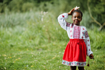 Portrait of african girl kid in traditional clothes at park.