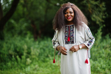 Portrait of african woman in traditional clothes at park.