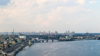 Top view of the old historical part of the city of Kiev. Vozdvizhenka area on Podol and the Dnieper river from the pedestrian bridge. Beautiful city landscape. 