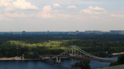 Top view of the old historical part of the city of Kiev. Vozdvizhenka area on Podol and the Dnieper river from the pedestrian bridge. Beautiful city landscape. 