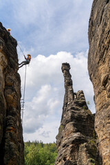 rock climbers rappelling from the  top of a rock pillar in the Elbsandstone mountains in Saxon Switzerland