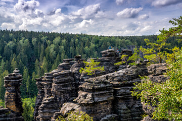 Fototapeta na wymiar rock climbers enjoy the view from the top of a rock bastion in the Elbsandstone mountains in Saxon Switzerland
