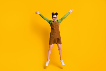 Fototapeta na wymiar Full length photo of enthusiastic cheerful girl hipster jump enjoy rejoice wear green sweater skirt overall isolated over bright shine color background