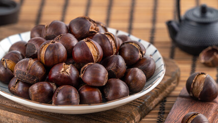 Delicious cut roasted chestnuts with oil and sugar, healthy eating snack in life, close up.