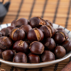 Delicious cut roasted chestnuts with oil and sugar, healthy eating snack in life, close up.