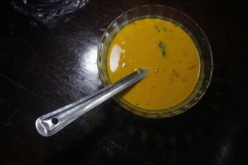 Spoon on a glass bowl with curry