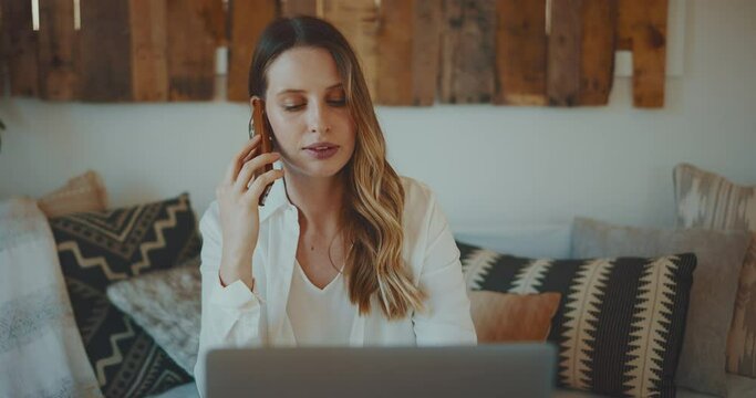 Woman speaking on phone while working from home, remote work concept