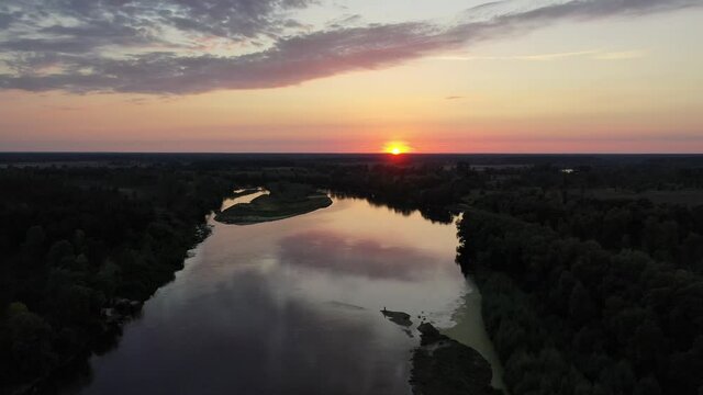 Aerial view. Beautiful sunset over the Desna river. Untouched nature by the river. River in the forest.