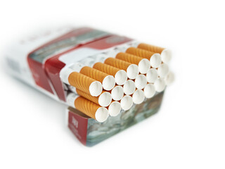 Pack full of filtered cigarettes on white isolated background.