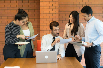 Asian teamwork business people working in modern office .Group of man and woman focus to the...