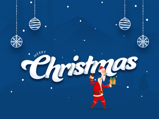 Merry Christmas Font with Cartoon Santa Claus Holding Gift Box, Jingle Bell and Hanging Baubles on Blue Background.