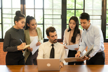 Asian teamwork business people working in modern office .Group of man and woman focus to the...