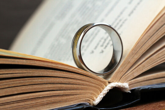 Golden ring and a book - Powered by Adobe