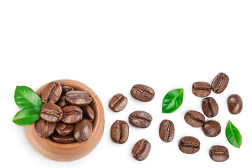 Heap of roasted coffee beans with leaves isolated on white background . Top view. Flat lay.