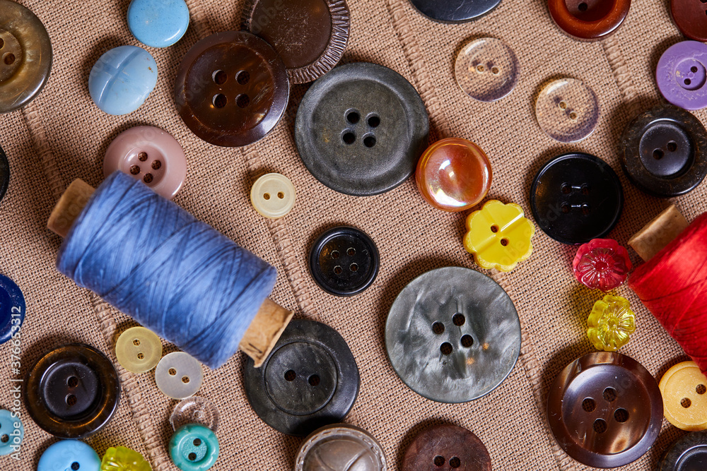 Poster background and texture of multicolored antique buttons and sewing tools