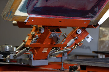 Fototapeta premium Print screening apparatus. serigraphy production. printing images on t-shirts in a design studio.