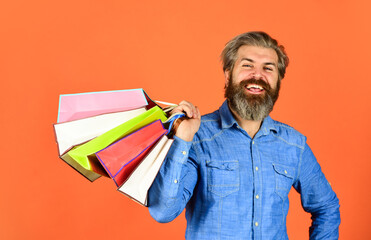 Black Friday. Cyber monday sale. Boost sales. Profitable deals. Retail concept. Happy holidays. Handsome buyer. Free shipping. Bearded man hold shopping bags. Seasonal sale. Hipster buying sale price