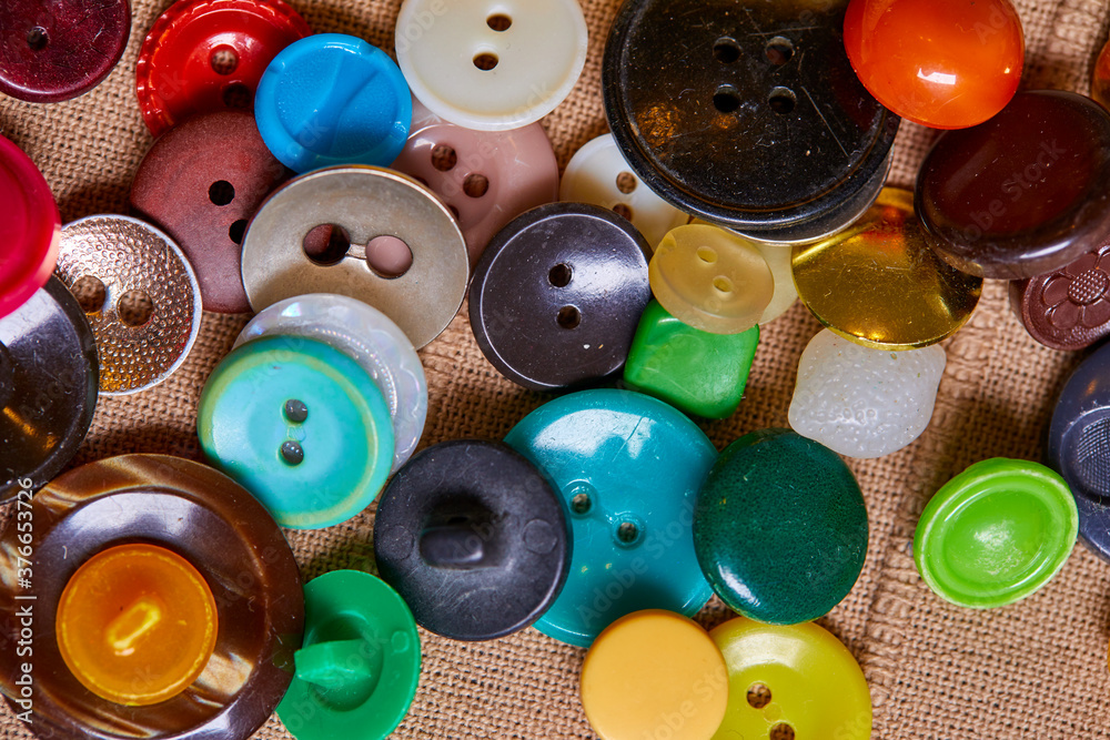 Poster background and texture of multicolored antique buttons and sewing tools