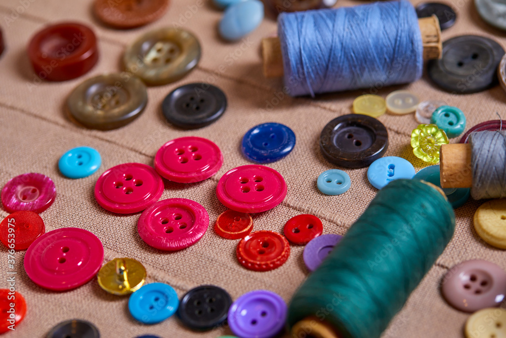 Poster Background and texture of multicolored antique buttons and sewing tools