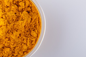 natural turmeric powder on white acrylic background