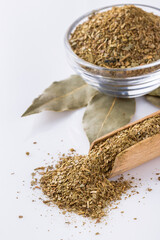 ground dried bay leaf on white acrylic background