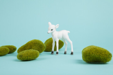 minimal white baby deer and moss