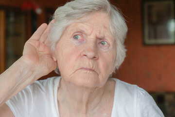 Old woman having difficulty in hearing