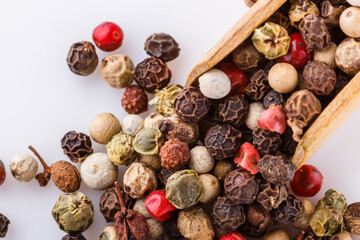 mix of peppercorns on white acrylic background