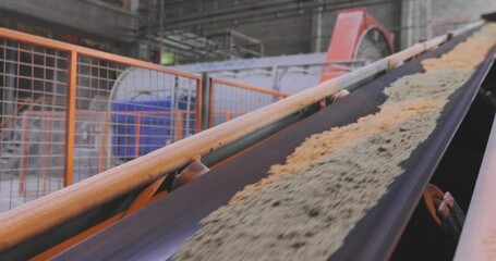 Conveyor belt line at the factory, conveyor belt with sand and metal balls