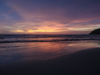 Fototapeta na wymiar Yellow, orange, pink and purple sunset in the beach 