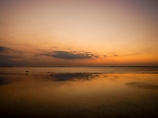 Fototapeta na wymiar Yellow, orange, pink and purple sunset in the beach.
