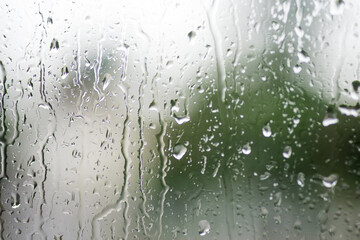 Creative background from rain drops on a glass window.