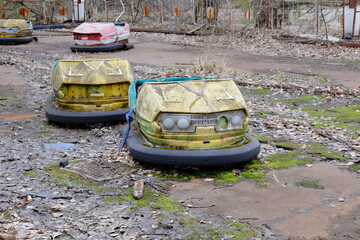 Cars in an abandoned amusement park in Pripyat. Rusty deserted attractions.