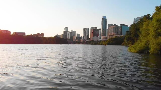 Low Drone shot that pans from the shore towards downtown Austin Texas. Shot August 2020