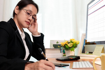 Business woman working in office with computer thinking analysis stock chart. business people working at home with PC screen. Business and finance ,work at home concept