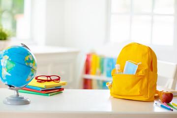 Backpack of school child. Face mask and sanitizer.