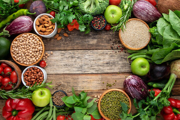 Vegetables, cereals on a wooden background. Vegan food frame. View from above.