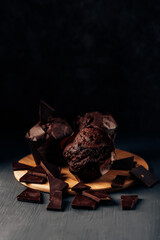 chocolate cupcakes close up on a dark background with bitter chocolate