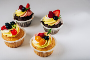 chocolate cupcakes with cream and fresh berries
