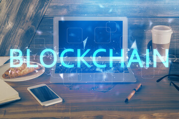 Double exposure of blockchain theme hologram and table with computer background. Concept of bitcoin...